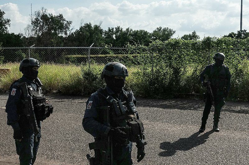 Members of Mexico’s state police go on patrol Oct. 19 in Culiacan. Mexican officials have responded with alarm to President Donald Trump’s comments that he would label Mexican drug cartels as terrorist organizations, fearing complications in security and trade relations. 