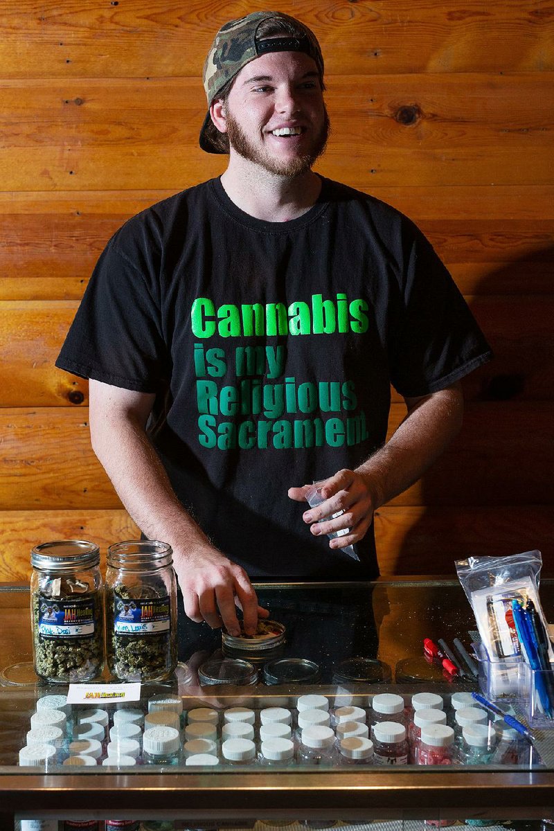 Shane Hollis stands ready at Jah Healing Church to provide churchgoers the cannabis sacrament of their choice. In return, they are asked for a donation. 