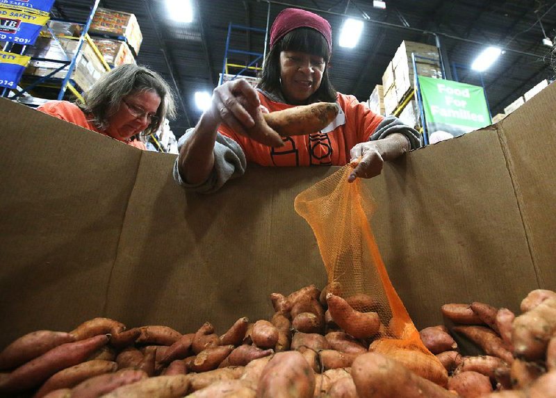 Regina Norwood bags sweet potatoes at Ingathering, the Arkansas Conference of the United Methodist Church’s largest annual volunteer event, at the Arkansas Foodbank in Little Rock on Nov. 23, 2019. 