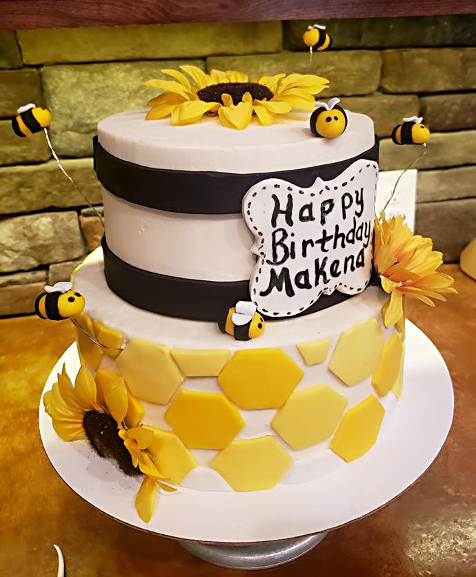 Courtesy photos/McDonald County Press Little bees flying around a cake and a honeycomb pattern created a real look for some local beekeepers who wanted their child's first birthday cakes to follow a bee theme. Blissful Bakery owner Misty Walker created some buzz when she whipped up a bee-themed birthday cake and a smash cake for a one-year-old. Walker painstakingly created little edible bees out of icing, along with a honeycomb look. Walker makes all of her cakes and icing from scratch. The Anderson-based bakery stays busy throughout the year, but has recently kicked into high gear for the holiday season.