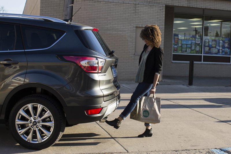 This undated photo provided by Ford shows the hands-free-opening liftgate for the Escape SUV. Power liftgates come in handy but are largely offered as a feature on an upper trim level or an extra-cost option on wagons and SUVs. (Ford Motor Co. via AP)