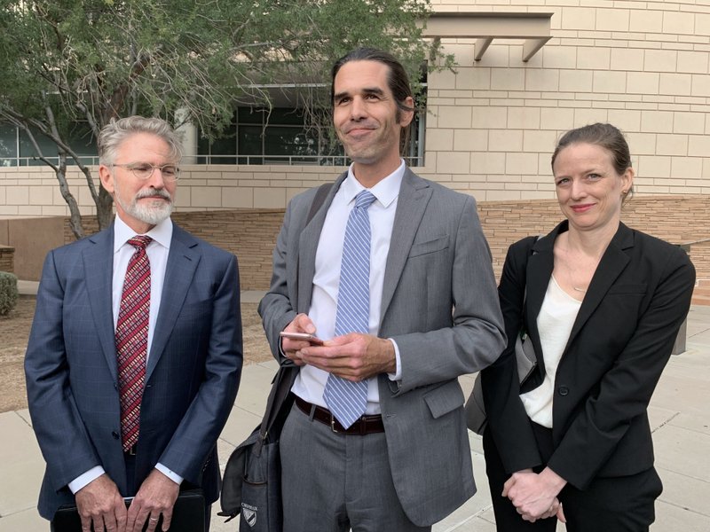 Scott Warren, center, of Ajo, Ariz. celebrates with his attorneys Amy Knight, right, and Greg Kuykendall outside court in Tucson, Ariz. on Wednesday, after being acquitted of two counts of harboring in a case that garnered international attention. Prosecutors said Warren illegally helped two migrants avoid authorities. He said he was fulfilling his humanitarian duties by helping two injured men. - Photo by Astrid Galvan of The Associated Press story.lead_photo.caption