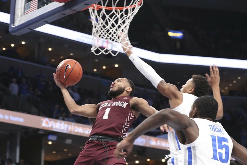 UALR’s Markquis Nowell (1) is guarded by Memphis guard Boogie Ellis, right rear, and  forward Lance Thomas (15)as he goes up for a basket during the first half of an NCAA college basketball game Wednesday, Nov. 20, 2019, in Memphis, Tenn. 