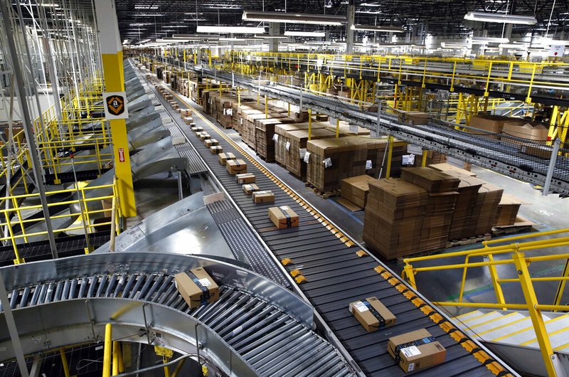 In this Aug. 3, 2017, file photo, packages ride on a conveyor system at an Amazon fulfillment center in Baltimore. (AP Photo/Patrick Semansky, File)