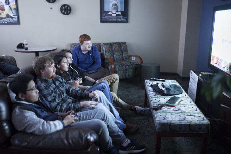 Students Phat Le of Springdale (from left), Miles Casey of Siloam Springs, Jakelin Calleros of Lowell, Steven Beard of Bella Vista and Brennan Kitchens of Centerton play Super Smash Bros. in the Northwest Arkansas Community College game room in Bentonville. The college is studying the possibility of adding dormitories to its campus. 