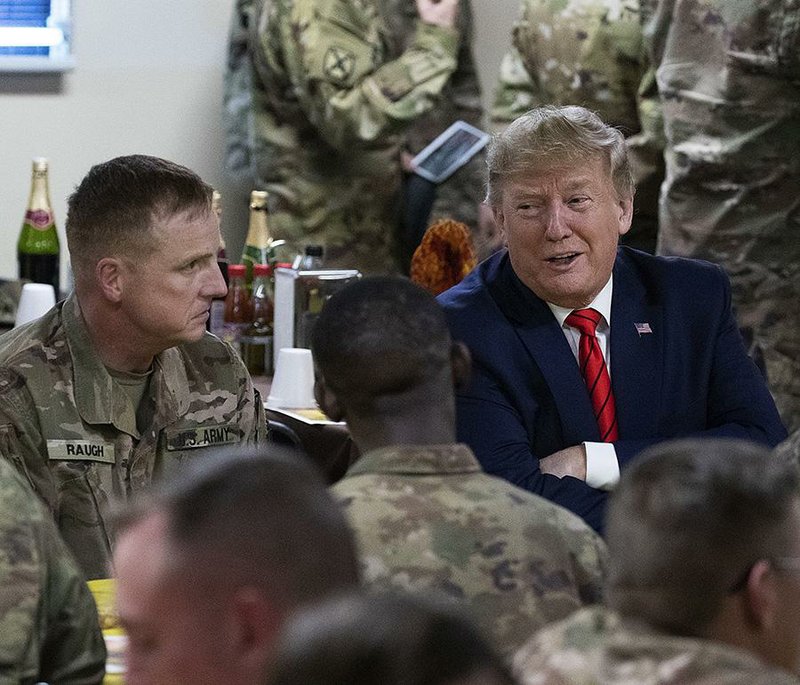 President Donald Trump talks with members of the military Thursday during a surprise Thanksgiving Day visit at Bagram Airfield in Afghanistan. 