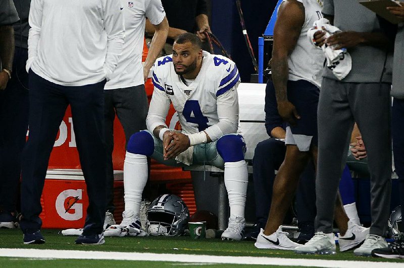 Dallas Cowboys quarterback Dak Prescott sits on the bench late in the second half of the Cowboys’ loss to the Buffalo Bills on Thursday. It was Dallas’ sixth loss in the past nine games. 