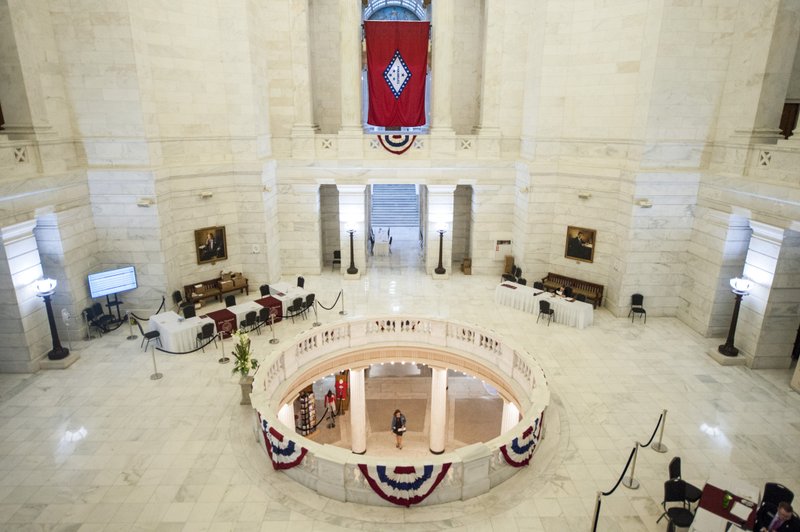 In this file photo a person passes under an empty rotunda at the Arkansas State Capitol Building in Little Rock.
