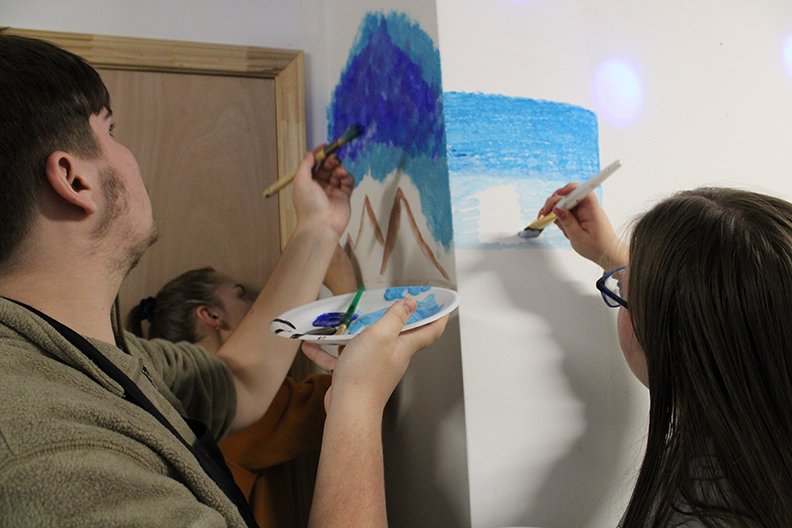Three Upward Bound students, above, paint various things on the walls at the C4K studio. Each student was asked to paint something related to what they want to be when they grow up. - Photo by Tanner Newton of The Sentinel-Record