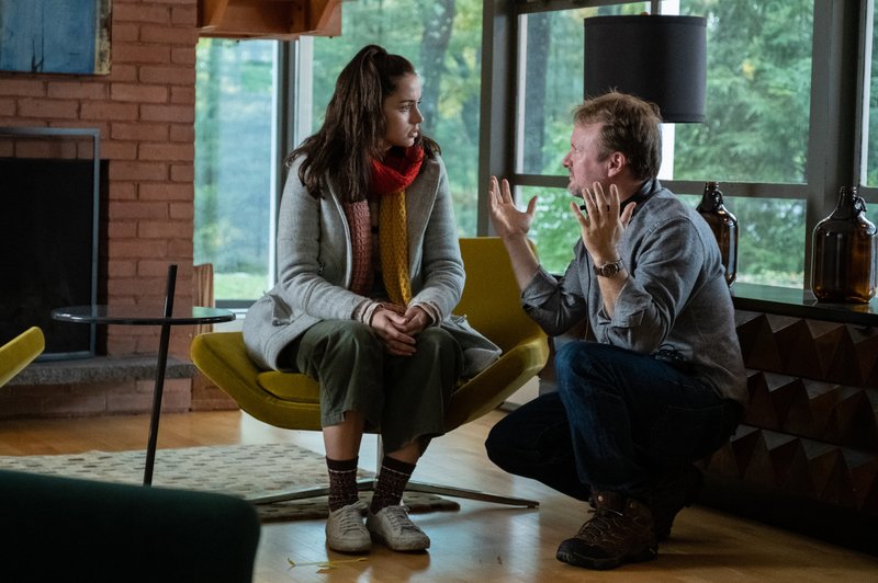 Director Rian Johnson works with Ana de Armas on the set of Knives Out. 