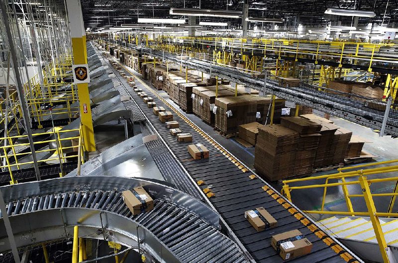 A conveyor system moves packages along at an Amazon shipping center in Baltimore. Eyes will be on Amazon as the holiday shopping season tests its promise of one-day shipping for Prime members. 
