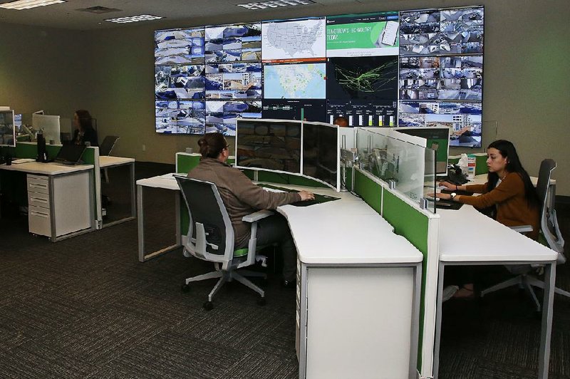 Paycom security workers monitor video screens in the command center at the company’s Oklahoma  City campus earlier this week. 