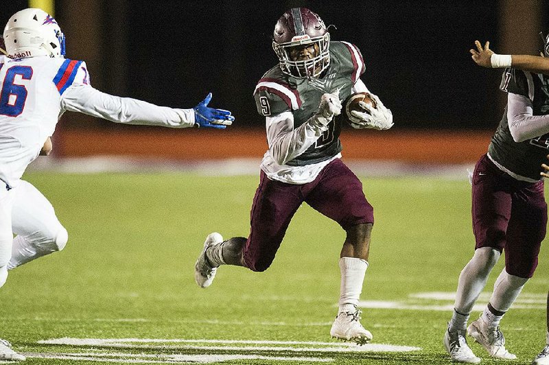 FILE - Benton running back Casey Johnson (right) avoids a tackle  by West Memphis’ Davion Eason on Nov. 29.