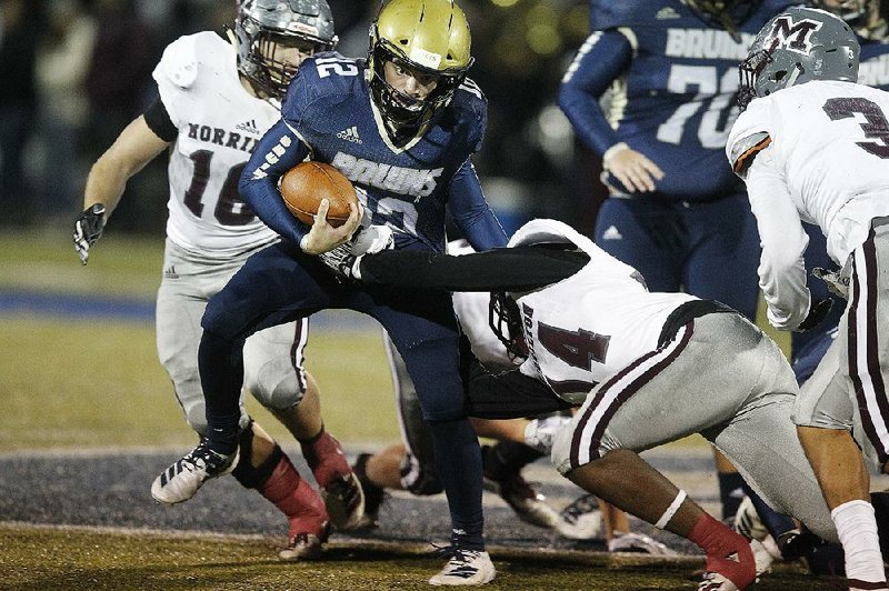 Pulaski Academy quarterback Braden Bratcher (12) tries to shake off Morrilton defensive back Jaylan  Mullins (14) during the second quarter of the Bruins’68-41 victory Friday at Hatcher Field in Little Rock. More photos available at arkansasonline.com/1130pa/.