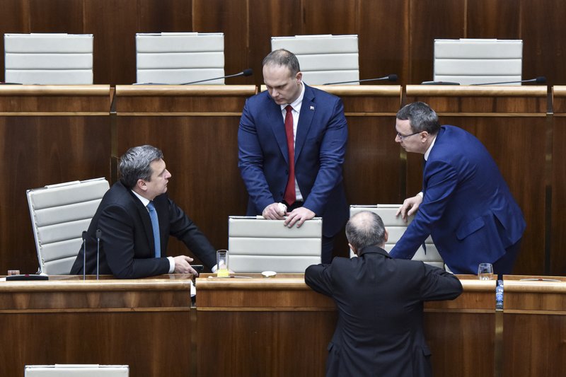 From left, Parliamentary Chair Andrej Danko (SNS), MP Radovan Balaz (SNS), MP Tibor Bernatak (SNS) during a Parliamentary session in Bratislava, Slovakia, Friday, Nov. 29, 2019. Lawmakers in Slovakia are scheduled to debate a proposed law that would compel women seeking an abortion to first have an ultrasound and listen to the heartbeat of the embryo or fetus, a move many groups have decried as a backward step for women's rights.  (Pavol Zachar/TASR via AP)