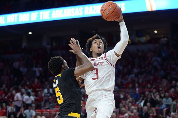 Arkansas guard Desi Sills (3) reaches to score Saturday, Nov. 30, 2019, as he is fouled by Northern Kentucky Bryson Langdon during the first half of play in Bud Walton Arena. 