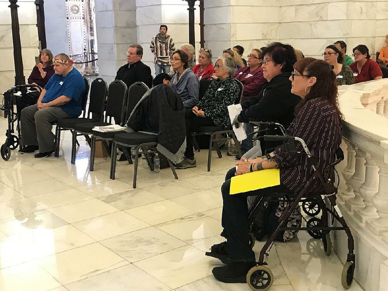 Kerry Heffner (front right) listens to speakers at a Don’t Punish Pain rally at the state Capitol in October. Heffner and others with chronic pain say opioids work better than other treatments. 