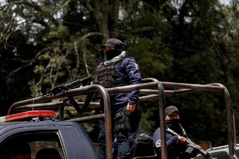 Members of an armed civilian avocado police force go on patrol earlier this year in Tancitaro in Mexico’s Michoacan state, where gangsters torched two avocado packing plants and abducted the son of a prominent packer. “It’s safe here now,” the sister of the abducted boy said of the civilian police force. 