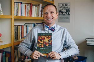 Photo Submitted Professor Jacob Stratman holding a copy of his book What I Have I Offer with Two Hands. The professor will have a book signing at 7:30 p.m. Tuesday at JBU's Simmons Great Hall.