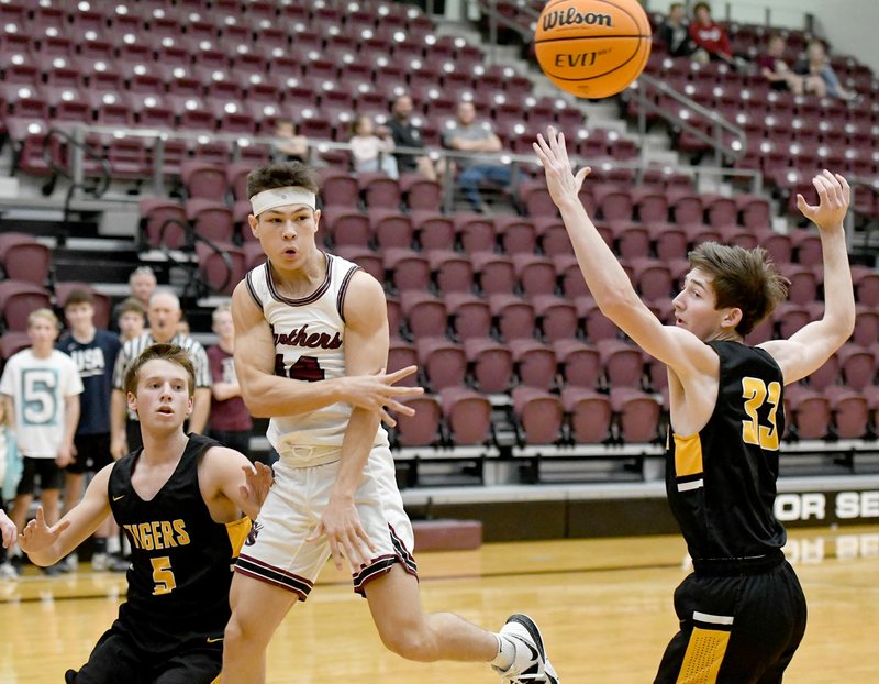 Bud Sullins/Special to Siloam Sunday Siloam Springs junior Landon Ward, middle, looks for a pass as Prairie Grove's Cole Vertz, left, and Alex Edmiston, right, defend on the play Tuesday at Panther Activity Center. Siloam Springs defeated Prairie Grove 53-51.