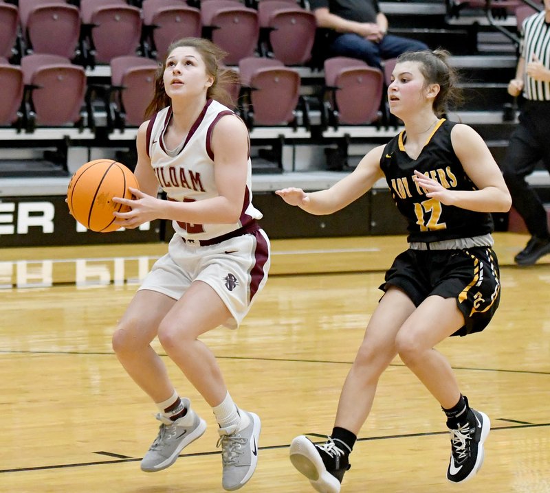 Bud Sullins/Special to Siloam Sunday Siloam Springs senior Brooke Henderson, left, drives to the basket Tuesday as Prairie Grove's Torie Price gives chase. The Lady Tigers defeated the Lady Panthers 59-55.