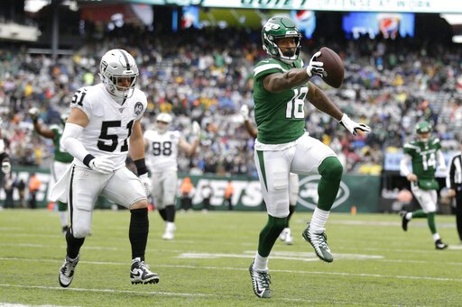 New York Jets wide receiver Demaryius Thomas (18) runs away from Oakland Raiders inside linebacker Will Compton (51) for a touchdown during the first half of an NFL football game Sunday, Nov. 24, 2019, in East Rutherford, N.J. The touchdown was later nullified by penalty. (AP Photo/Adam Hunger)