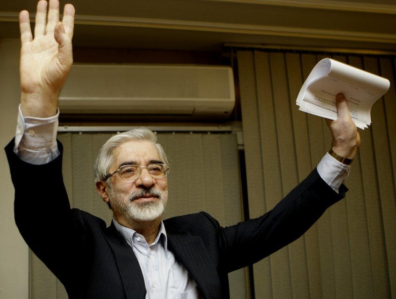 This Friday, June 12, 2009, file photo, shows Iranian reformist presidential candidate Mir Hossein Mousavi waving to the media during a late night press conference after polls closed in Tehran. (AP Photo/Kamran Jebreili)
