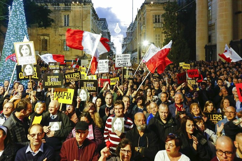 People stage a protest in La Valletta, Malta, Sunday, Dec. 1, 2019. Malta's embattled prime minister has received a pledge of confidence from Labor Party lawmakers amid demands for his resignation by citizens angry over alleged links of his former top aide to the car bomb killing of a Maltese anti-corruption journalist. Hours later, thousands of Maltese protested outside a courthouse demanding that Joseph Muscat step down. (AP Photo) story.lead_photo.caption