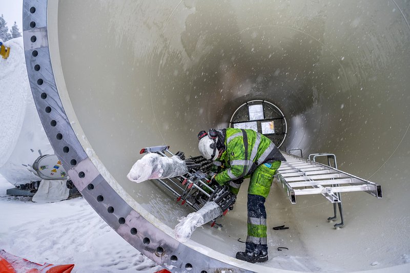 A contractor works inside a wind turbine tower waiting to be installed at the Markbygden wind park project near Pitea, Sweden recently. 