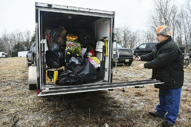 Bob Kostaras, of Jamison, Pa., on Sunday shows toys collected from riders at the fourth annual Dirty Santa Toy Run in New Castle Township, Pa. The event benefits the Marine Corps League Toys for Tots program. 