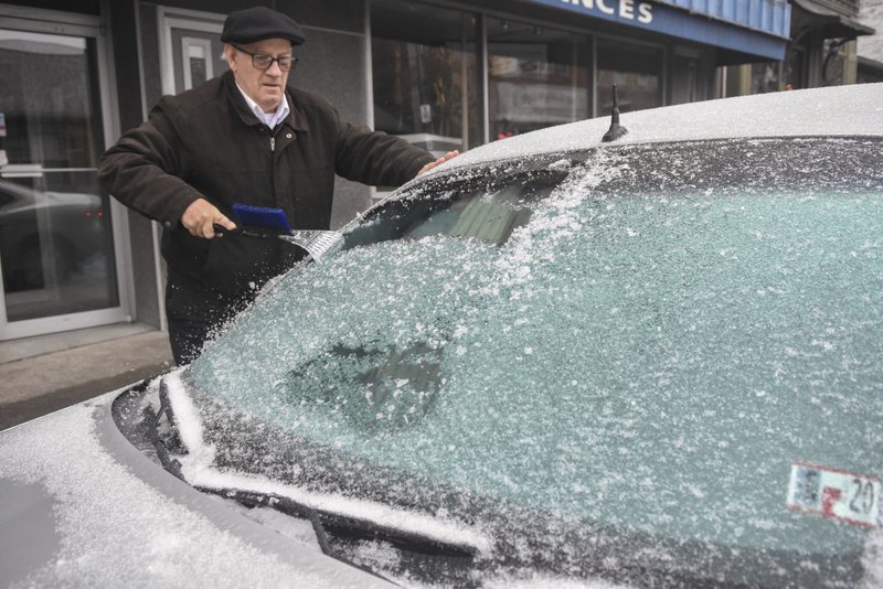 Paul Ciotti, of Minersville, Pa., scrapes ice off of his car windshield parked along Sunbury Street in Minersville, Pa., on Sunday. - Jacqueline Dormer/Republican-Herald via AP story.lead_photo.caption