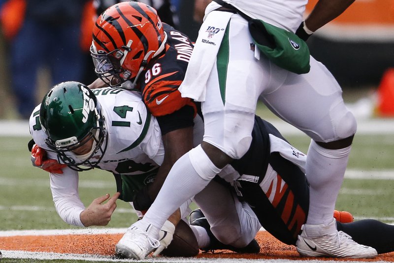 New York Jets quarterback Sam Darnold (14) is sacked by Cincinnati Bengals defensive end Carlos Dunlap (96) during the second half of Sunday's game in Cincinnati. - Photo by Gary Landers of The Associated Press story.lead_photo.caption