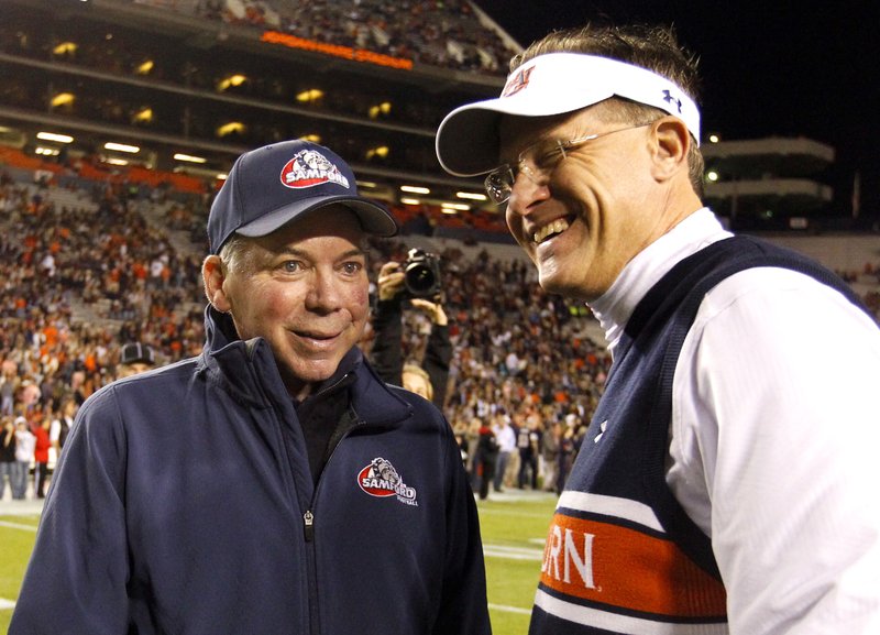 Samford head coach Pat Sullivan, left, meets with Auburn head coach Gus Malzahn before a Nov. 22, 2014, game in Auburn, Ala. Sullivan, the 1971 Heisman Trophy winner at Auburn who went on to coach TCU and Samford, died Sunday. He was 69. - Photo by Butch Dill of The Associated Press story.lead_photo.caption