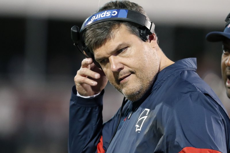 Mississippi head coach Matt Luke removes his headset during Thursday's game against Mississippi State, in Starkville, Miss. Mississippi has fired Luke, three days after his third non-winning season ended with an excruciating rivalry game loss. Athletic director Keith Carter said Sunday the decision to change coaches was made after evaluating the trajectory of the program and not seeing enough "momentum on the field." - Photo by Rogelio V. Solis of The Associated Press story.lead_photo.caption