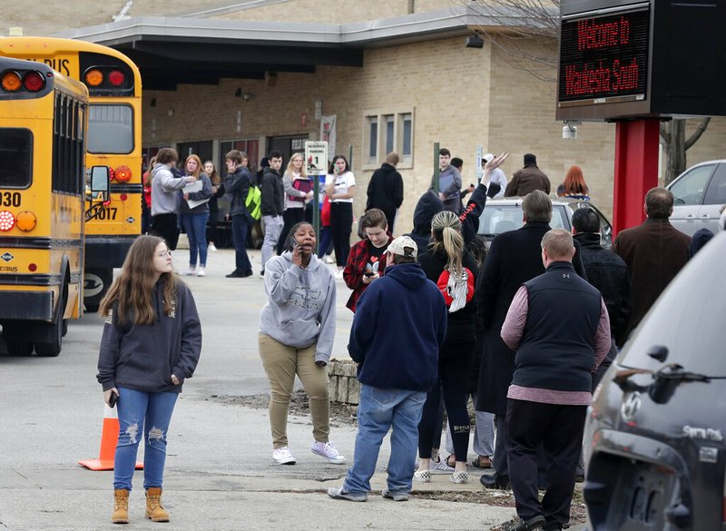 Waukesha South High School students find their waiting parents and friends and hug after they leave the building following shots fired inside the school, Monday, December 2, 2019. A suspect is in custody after a student exchanged gunfire with a school resource officer Monday morning, a spokeswoman for the school district confirmed. (Rick Wood/Milwaukee Journal-Sentinel via AP) story.lead_photo.caption