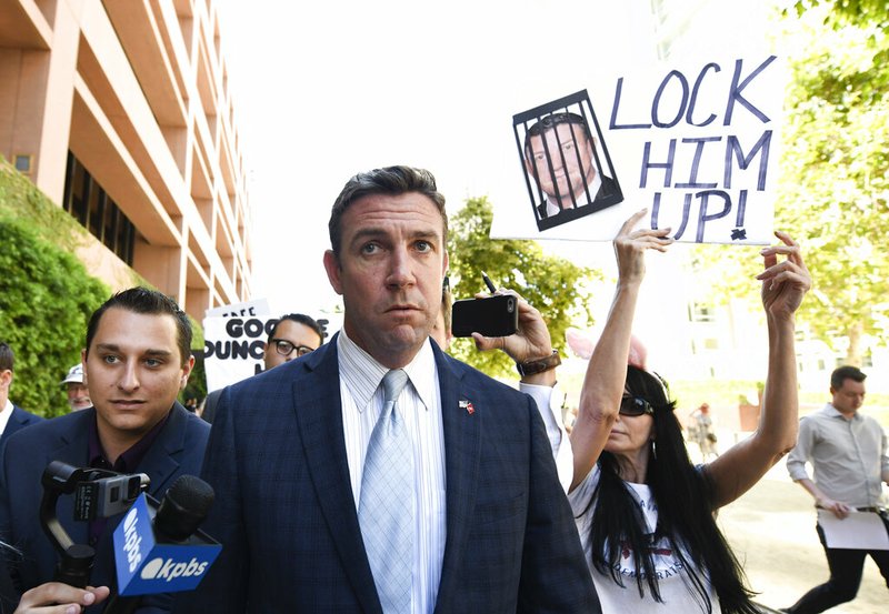 FILE - In this July 1, 2019, file photo, U.S. Rep. Duncan Hunter leaves federal court after a motions hearing in San Diego. Hunter says he will plead guilty on Tuesday to a charge of misusing campaign funds. The California Republican is facing charges he looted campaign cash to finance vacations, golf outings and other personal expenses, a judge said Monday, Dec. 2, 2019. (AP Photo/Denis Poroy, File)