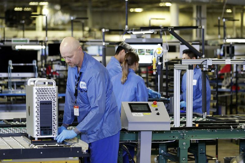 Workers assemble components last month at an Apple manufacturing plant in Austin, Texas. Factories in the U.S. have faced declining output since August, according to the Institute for Supply Management’s manufacturing index. 