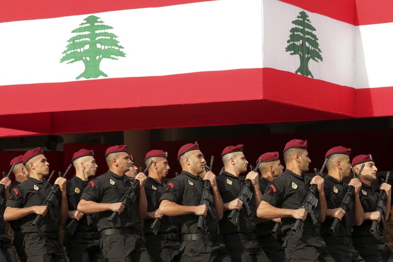 Lebanese marine special forces soldiers march during a military parade to mark the 76th anniversary of Lebanon's independence from France at the Lebanese Defense Ministry, in Yarzeh near Beirut, Lebanon, Friday, Nov. 22, 2019. Lebanon's top politicians attended Friday a military parade on the country's 76th Independence Day, appearing for the first time since the government resigned amid nationwide protests now in their second month. (AP Photo/Hassan Ammar)