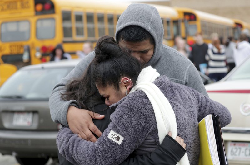 Becky Galvan, center, consoles her daughter, Ashley Galvan, a 15-year-old sophomore, with her father Jose Chavez outside Waukesha South High School in Waukesha on Monday, Dec. 2, 2019. Gunshots were exchanged between a student and a school resource officer inside Waukesha South High School, according to school officials. (Mike De Sisti/Milwaukee Journal-Sentinel via AP)