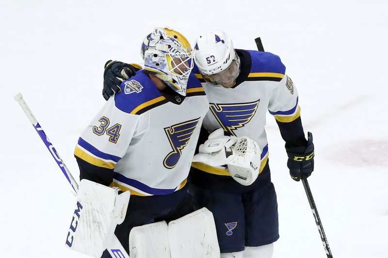 St. Louis Blues goaltender Jake Allen, left, and David Perron celebrate their win over the Chicago Blackhawks in Monday's game in Chicago. - Photo by Charles Rex Arbogast of The Associated Press story.lead_photo.caption