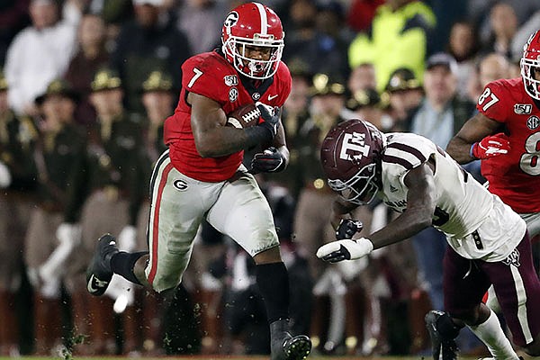 Georgia running back D'Andre Swift (7) is topped by Texas A&M linebacker Ikenna Okeke (20) in the second half of an NCAA college football game Saturday, Nov. 23, 2019, in Athens, Ga. Georgia won 19-13. (AP Photo/John Bazemore)


