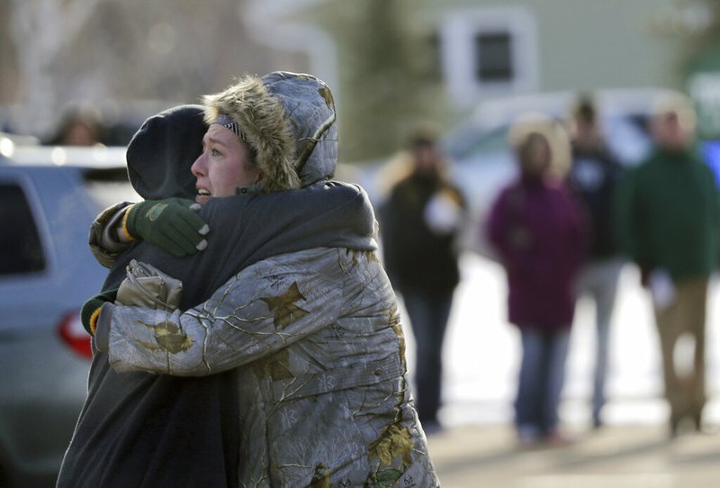 Sarah Rogstad, right, hugs Morgan Rogstad, grade 9, after being reunited at the Tipler Middle school reunification center on Tuesday December 3, 2019, in Oshkosh, Wis. Earlier, police responded to an officer invloved shooting at Oshkosh West High School after an armed student confronted a school resource officer. (Wm. Glasheen/The Post-Crescent via AP)