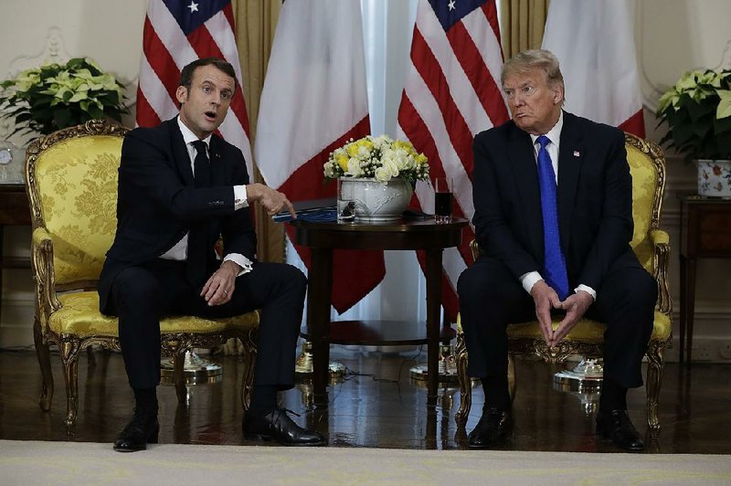 French President Emmanuel Macron and President Donald Trump exchange remarks Tuesday during a 45-minute appearance at the U.S. ambassador’s residence in London. More photos at arkansasonline.com/124summit/ 