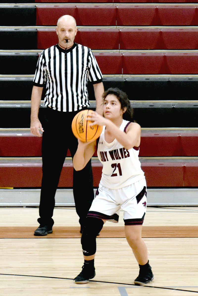 MARK HUMPHREY ENTERPRISE-LEADER Lincoln senior Tania Ortiz lines up a shot from the right wing during the Lady Wolves' 61-46 win over Shiloh Christian on Nov. 21 at Wolfpack Arena. Ortiz scored six points and helped Lincoln repeat the win by holding off Shiloh Christian, 40-35, on Nov. 25 during the second annual Turkey Shoot Tournament at Lincoln.