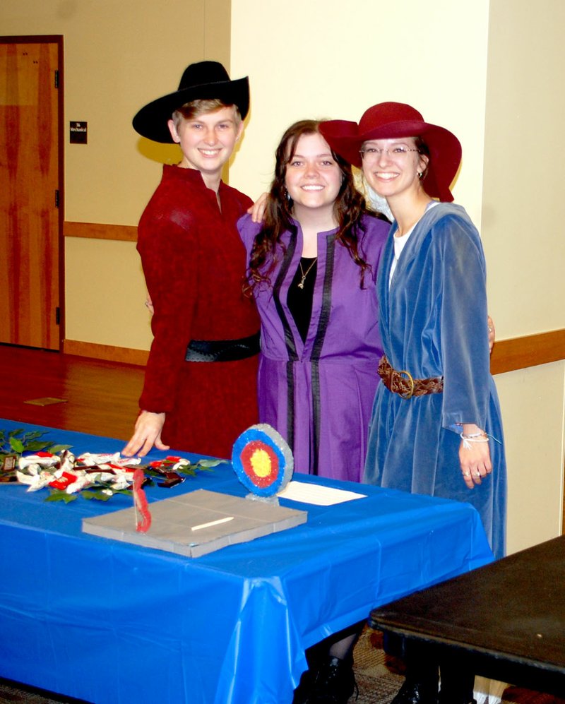 Marc Hayot/Herald Leader Karis Martin (left), Kaitlyn Bullington and Peyton Hoffman pose at the Robin Hood exhibit.