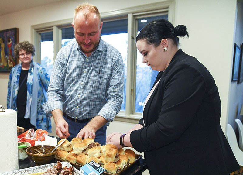 Hot Springs Area Community Foundation Youth Advisory Council adviser Brad Burleson, left, and YAC member Izzy Saettele prepare sandwiches ahead of a YAC reception at the home of Robert and Mary Zunick on Tuesday. - Photo by Grace Brown of The Sentinel-Record