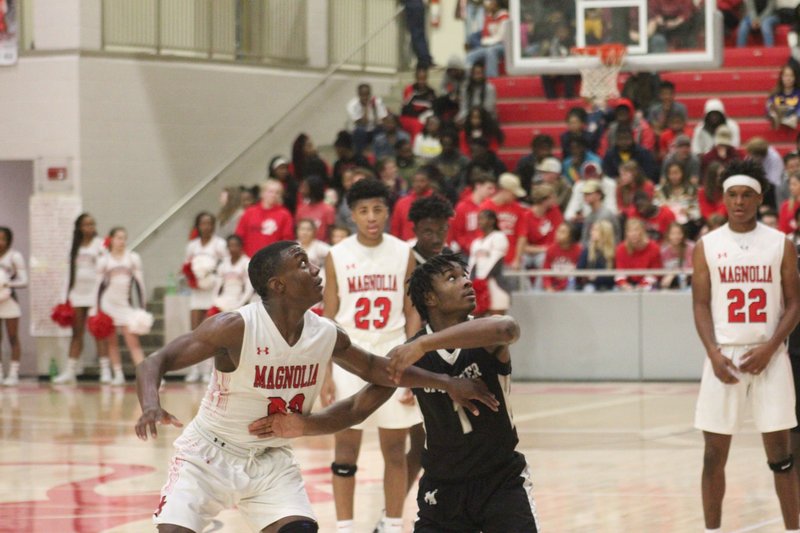 Magnolia sophomore Derrian Ford (20) tangles with a Smackover defender Tuesday during the Panthers blowout win over the Buckaroos.   