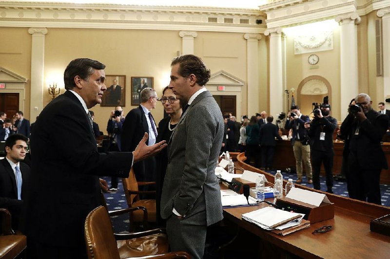 Constitutional law scholars Jonathan Turley (left) of George Washington University Law School, Pamela Karlan of Stanford Law School and Noah Feldman of Harvard Law School discuss differences of opinion on impeachment requirements Wednesday during a break in the House Judiciary Committee hearing. More photos at arkansasonline.com/125impeachment/ 