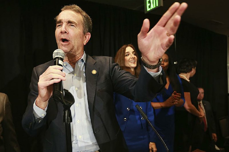 Virginia Gov. Ralph Northam speaks to supporters last month at a Democratic victory party in Richmond, Va. He says he is halting requests for federal approval on Medicaid work requirements. 