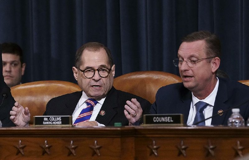 House Judiciary Committee Chairman Jerrold Nadler (left) and ranking member Doug Collins confer Wednesday at the close of the committee’s hearing on possible grounds for impeachment. Collins called the proceedings “simply a railroad job.” 